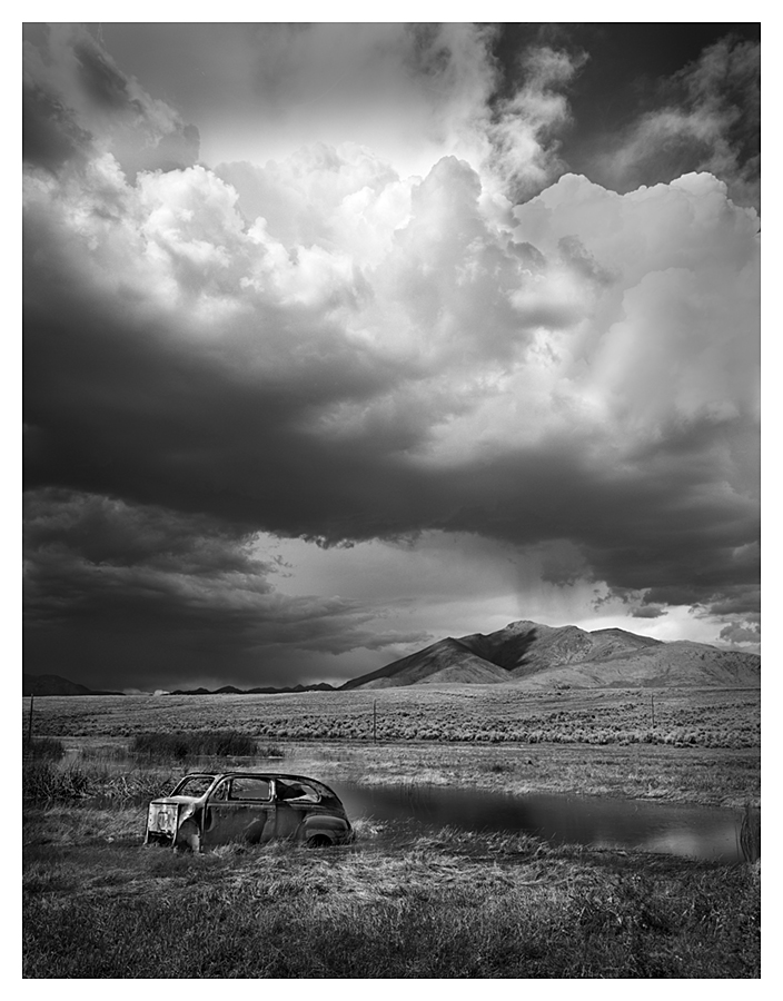 Derelict Car and Towering Sky